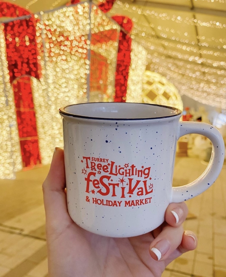 Hand holds Surrey Tree Lighting Festival mug