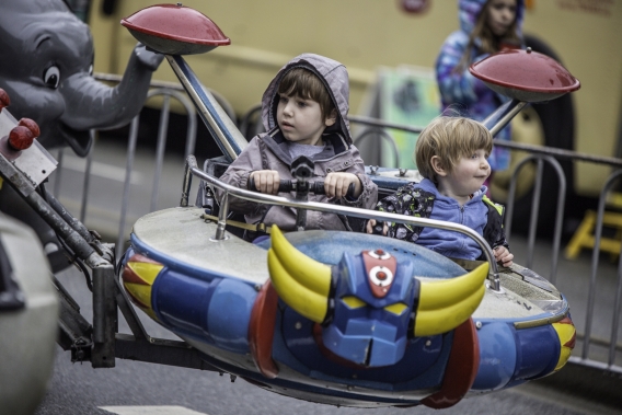 Two toddlers enjoy carnival ride