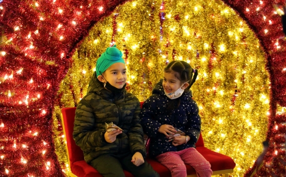Toddler delighted by Christmas lights and decorations
