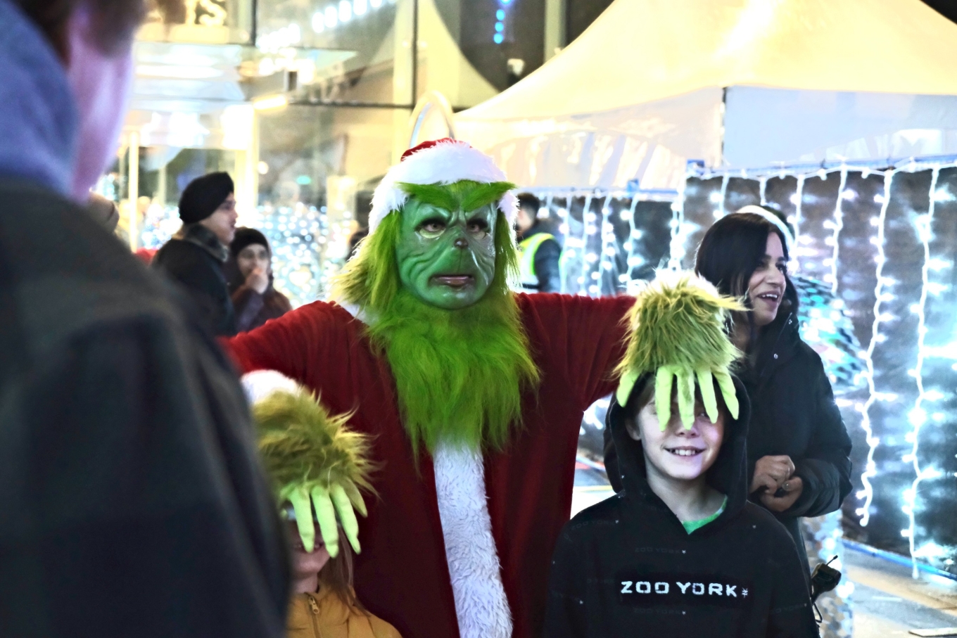 grinch touching a kids face